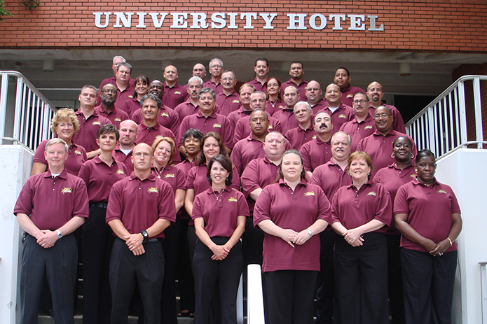 Image: Class #4 grouped outside a red brick building.