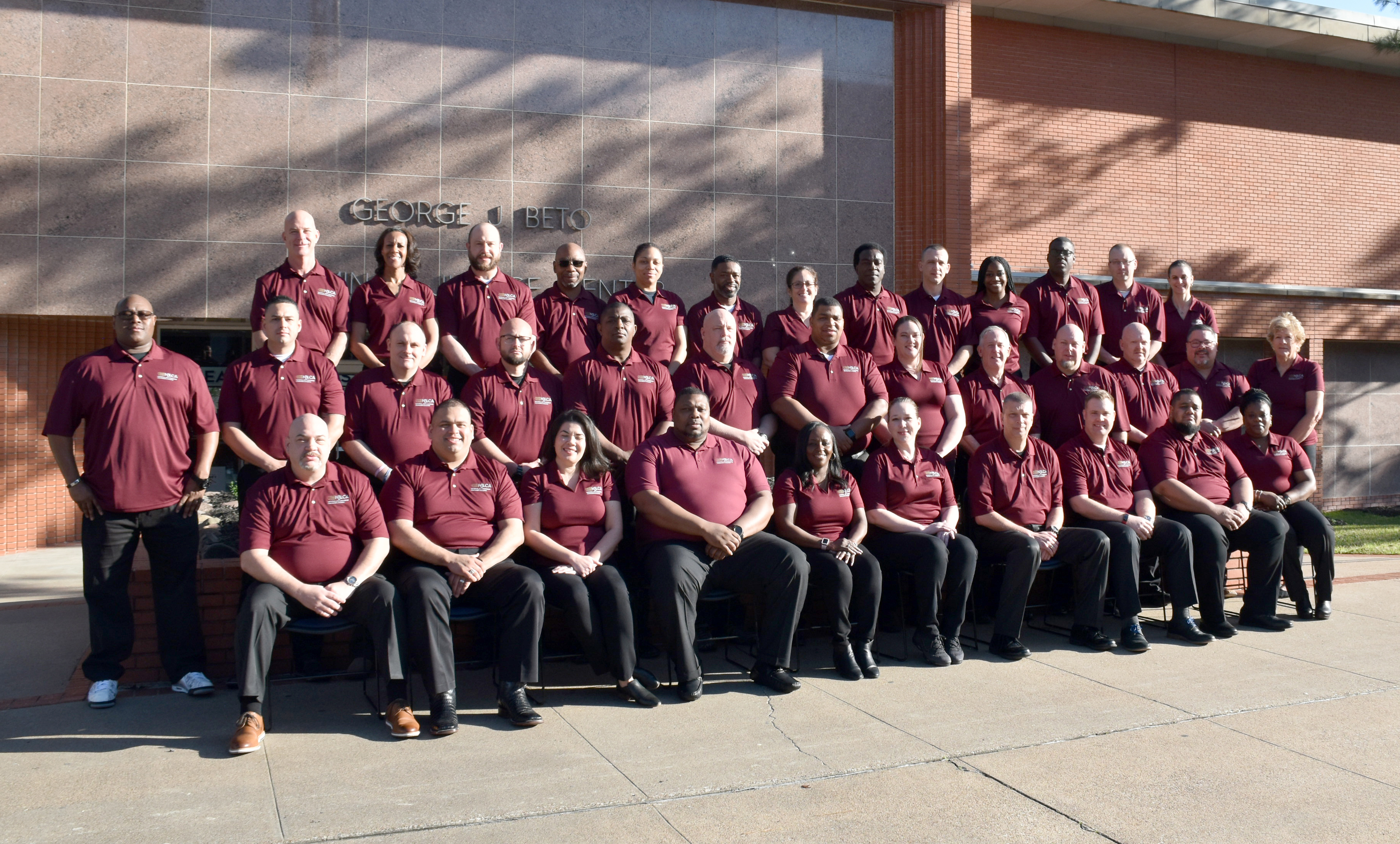 Image: Class #41 grouped outside a red brick building.