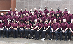 Image: Class #52 grouped in front of red brick building.