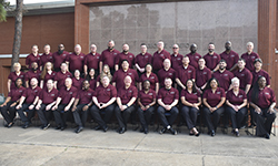 Image: Class #53 grouped in front of red brick building.